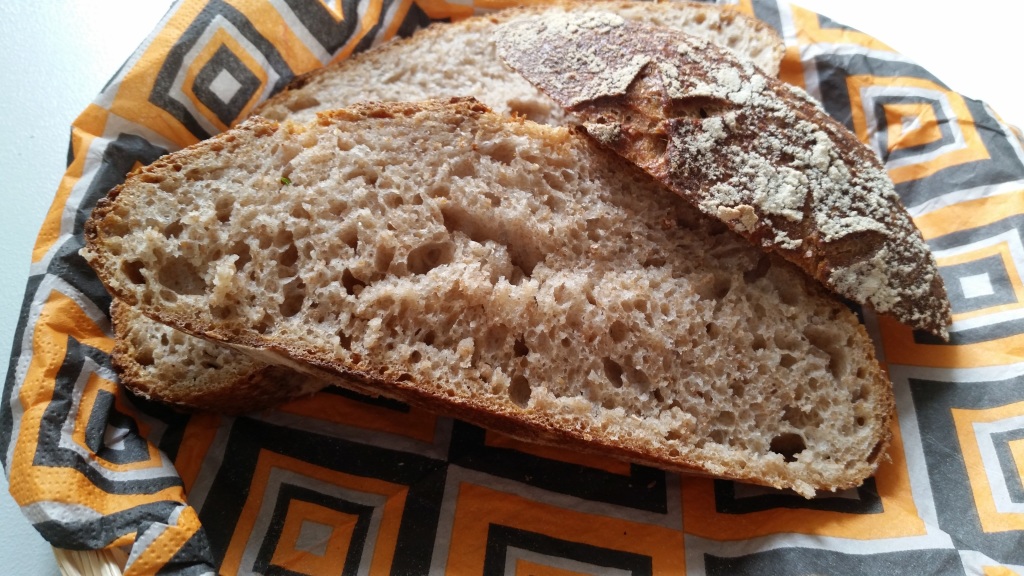 Sliced homemade spelt whole-grain loaf in basket