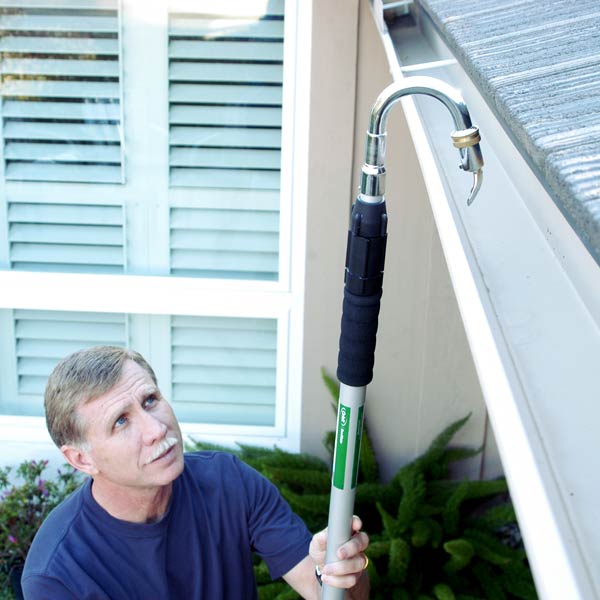 man cleaning his gutter