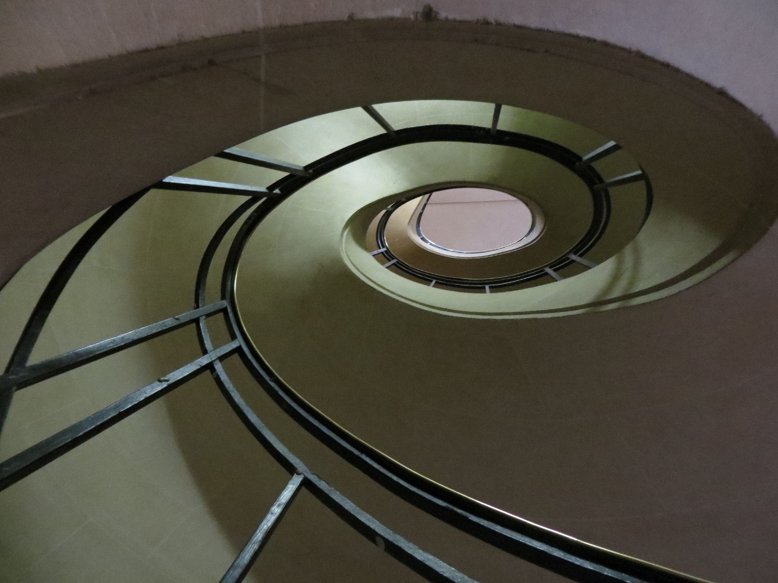 A spiral of a staircase taken from below.